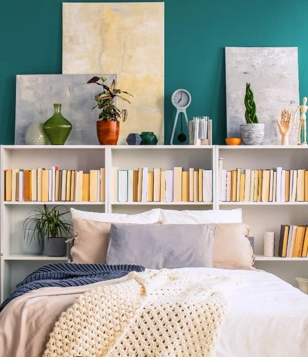 When there's no room for nightstands in your small bedroom, try using bookcases behind the bed as a nightstand alternative.